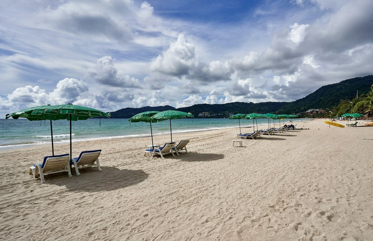 Phuket beach with sun loungers and umbrellas
